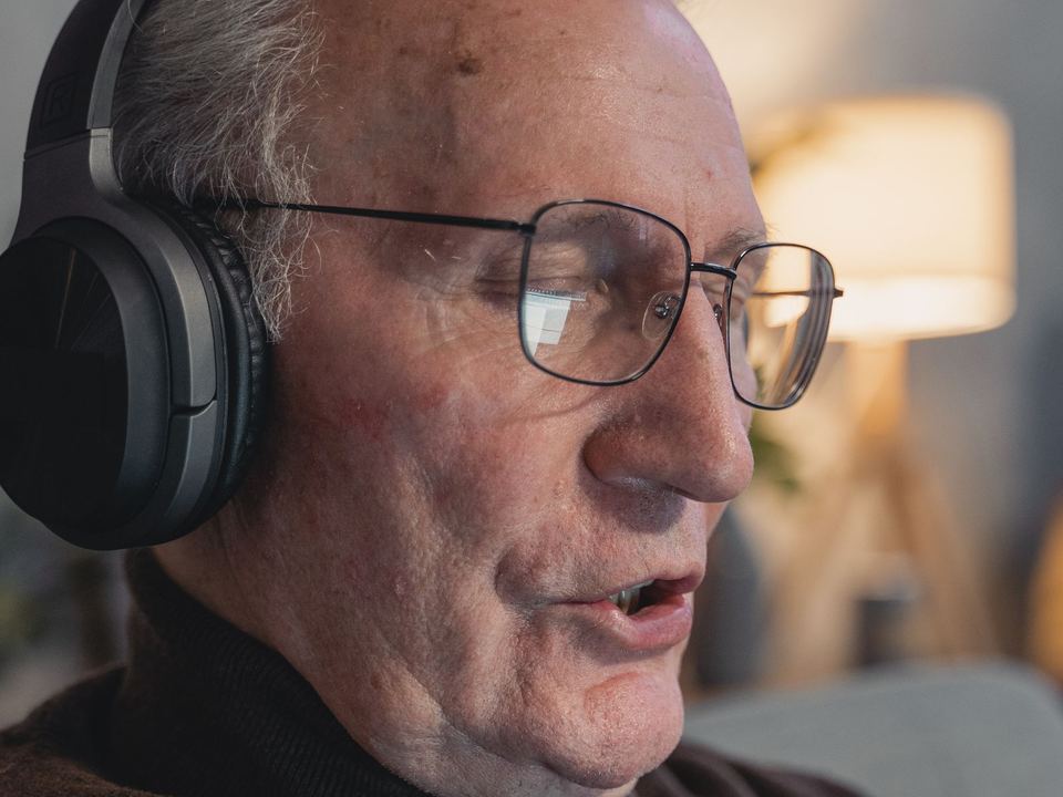 Older man wearing headphones