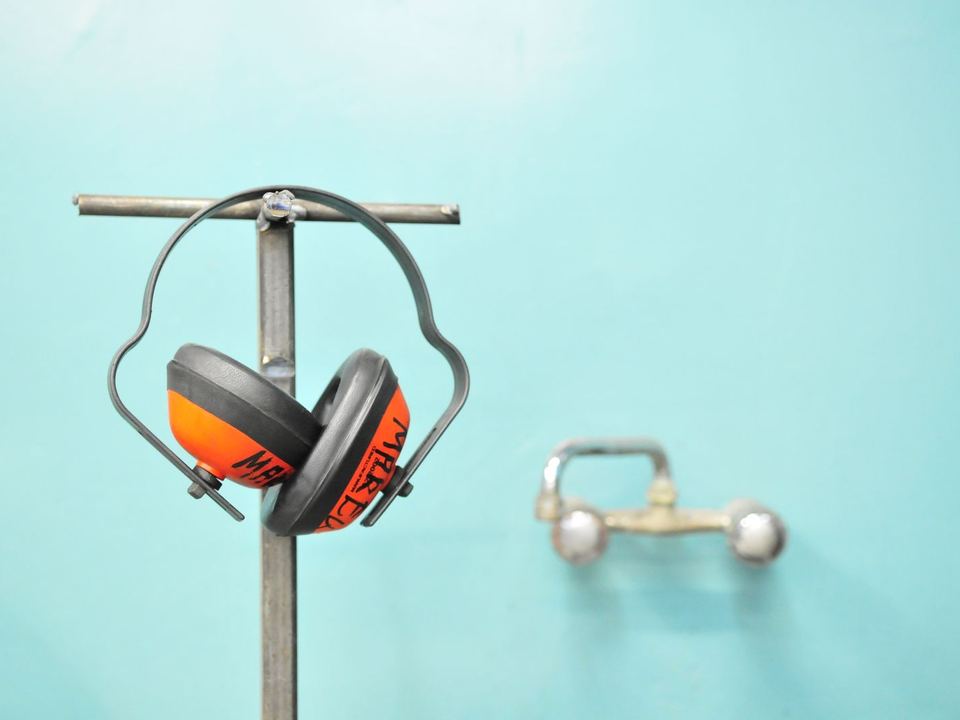 Ear defenders hanging on a stand